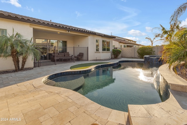 view of swimming pool featuring an in ground hot tub and a patio