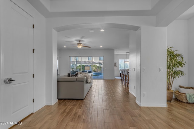 living room with light wood-type flooring and ceiling fan