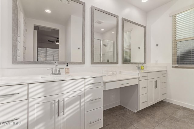 bathroom with tile patterned flooring, vanity, an enclosed shower, and ceiling fan