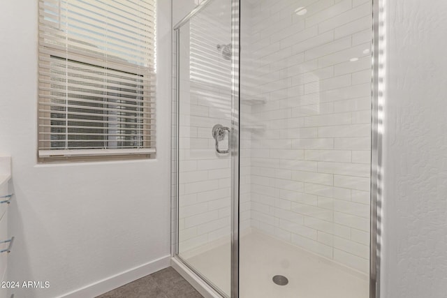 bathroom with tile patterned flooring and a shower with door