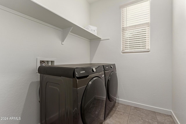 washroom with independent washer and dryer and light tile patterned floors