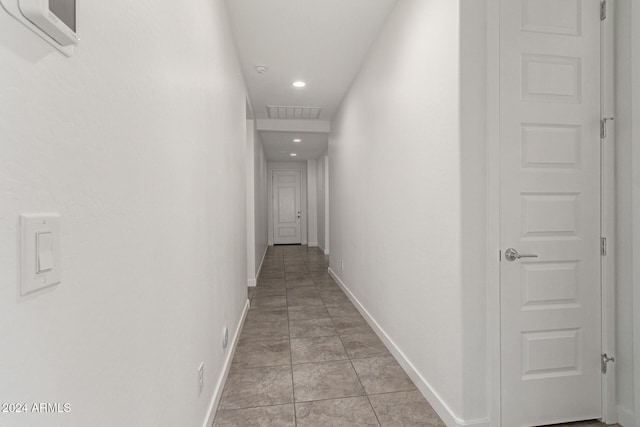 corridor featuring light tile patterned floors