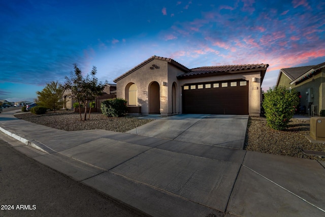 mediterranean / spanish house featuring a garage