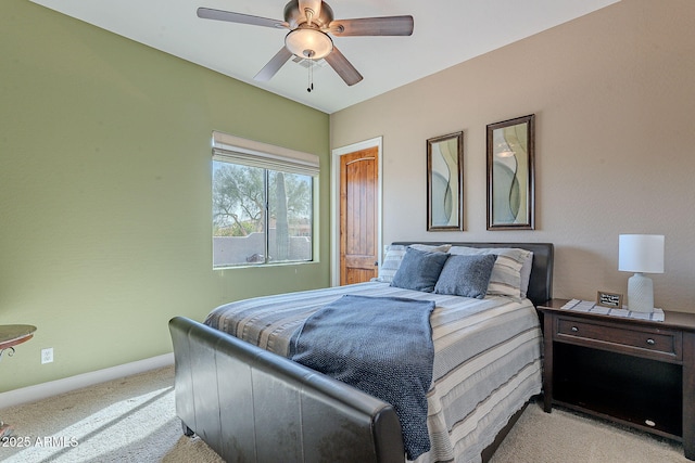 bedroom with light carpet, ceiling fan, and baseboards