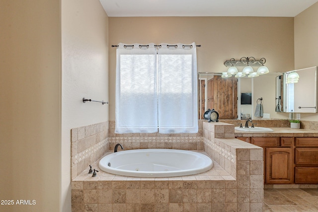 full bathroom featuring a healthy amount of sunlight, vanity, and a whirlpool tub