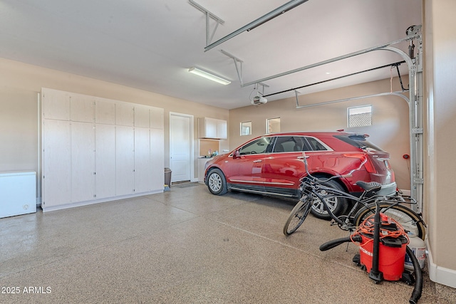 garage featuring fridge and a garage door opener