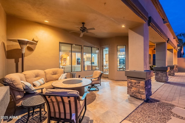 view of patio with ceiling fan and an outdoor living space