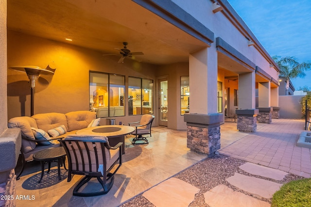 view of patio with a ceiling fan, outdoor lounge area, and fence