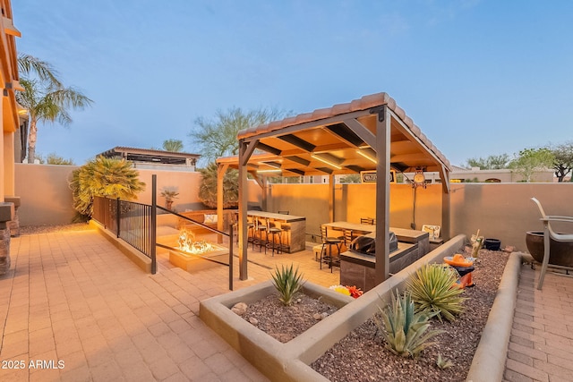 view of patio / terrace with an outdoor living space with a fire pit and a fenced backyard