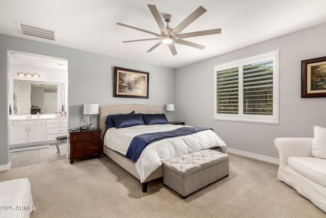 bedroom featuring light carpet, baseboards, connected bathroom, ceiling fan, and a sink