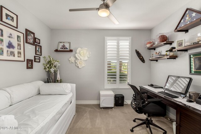 carpeted home office featuring ceiling fan and baseboards