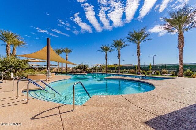 community pool featuring a patio area and fence