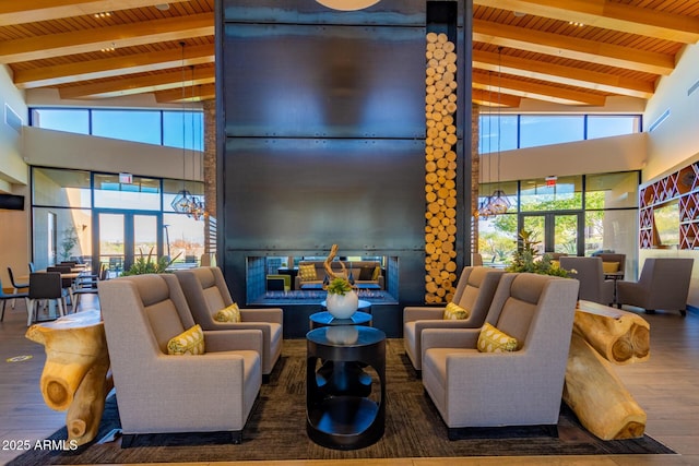 common area with wooden ceiling, beamed ceiling, and high vaulted ceiling