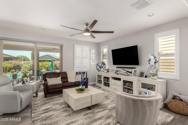 living room featuring wood finished floors, ceiling fan, recessed lighting, and baseboards