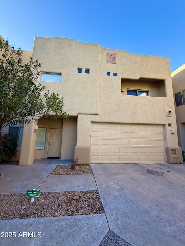 view of front facade featuring concrete driveway and stucco siding