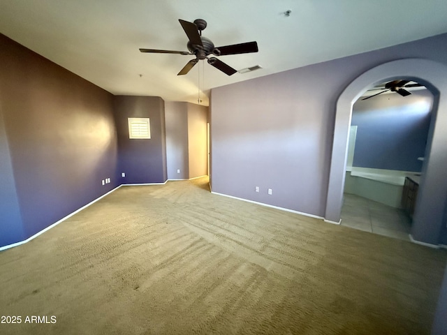 unfurnished bedroom featuring ceiling fan, carpet floors, visible vents, and baseboards