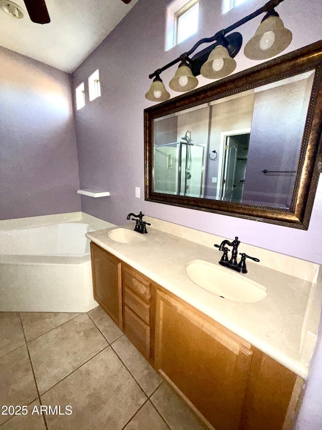 full bath featuring double vanity, a garden tub, a sink, and tile patterned floors