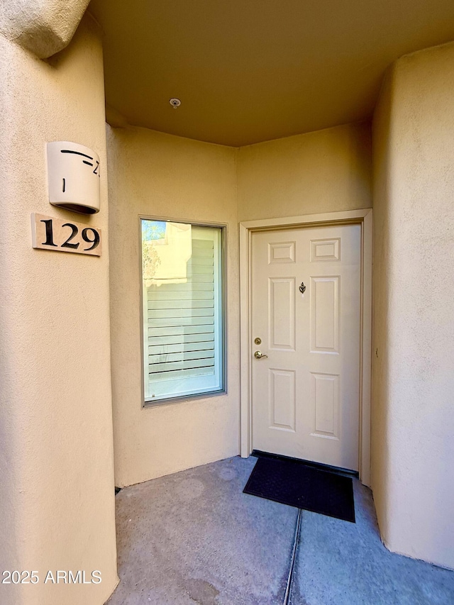 entrance to property with stucco siding