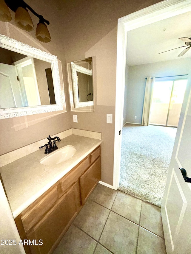 bathroom featuring ceiling fan, vanity, baseboards, and tile patterned floors