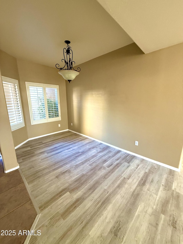 unfurnished dining area with light wood finished floors and baseboards