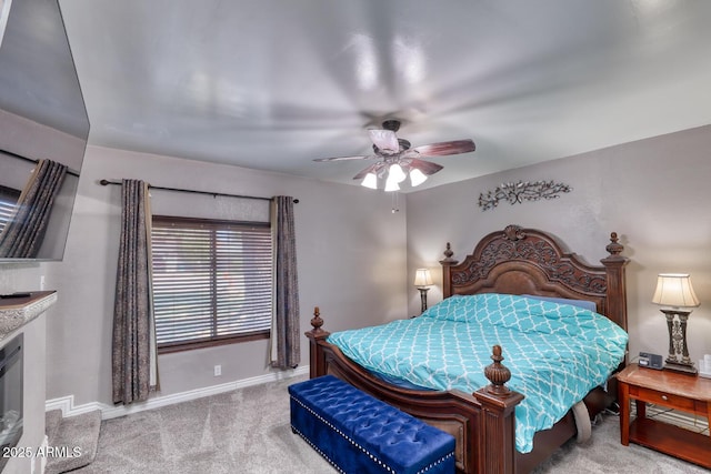 carpeted bedroom with baseboards and a ceiling fan