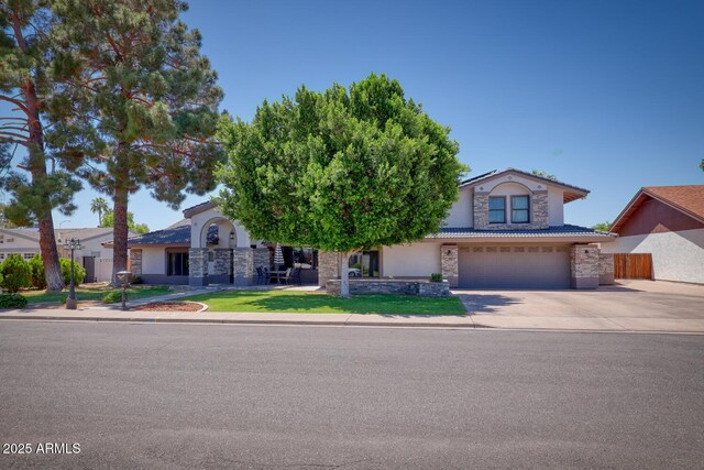 obstructed view of property featuring a garage, stucco siding, driveway, and stone siding