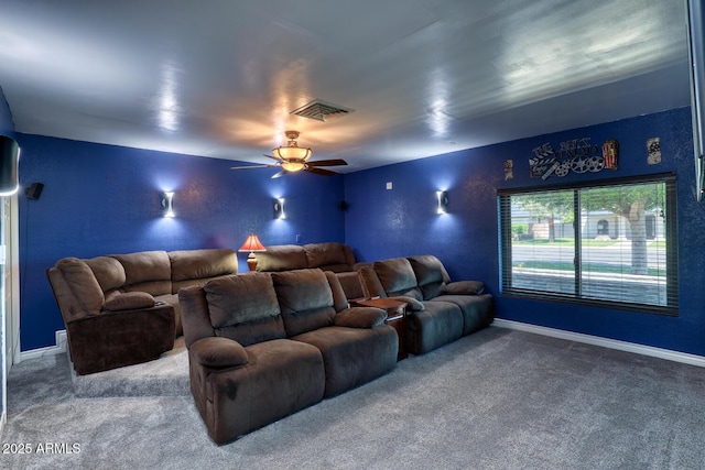 home theater room with carpet floors, a ceiling fan, baseboards, and visible vents