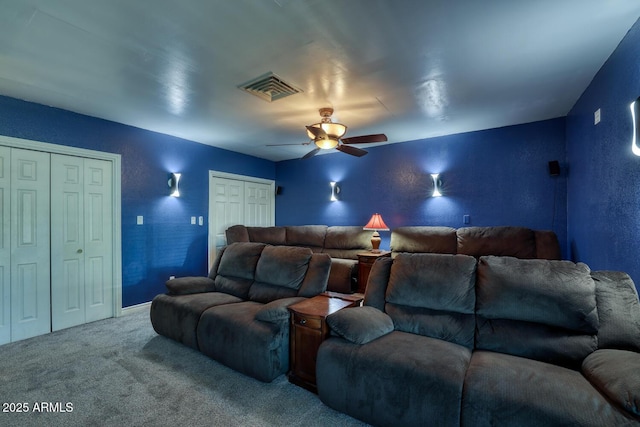 carpeted home theater featuring ceiling fan and visible vents