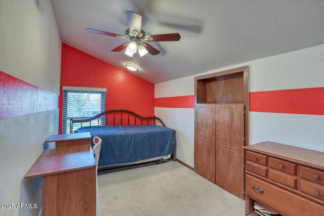 carpeted bedroom with ceiling fan and lofted ceiling