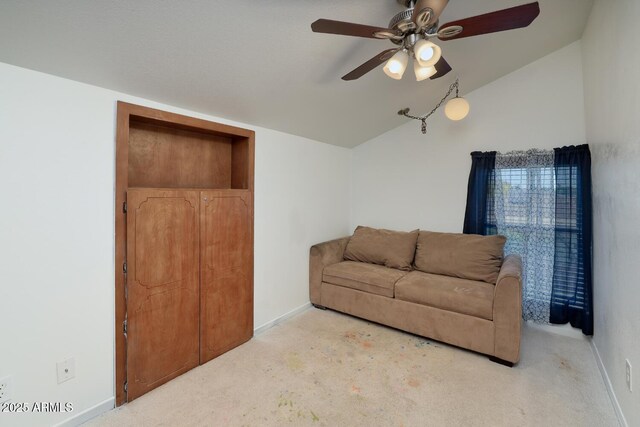 carpeted living room with baseboards, a ceiling fan, and lofted ceiling
