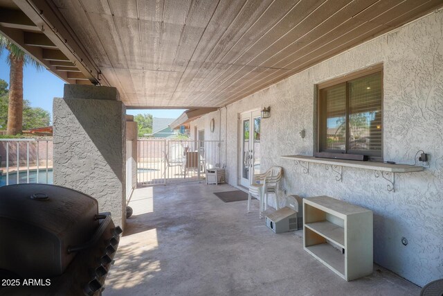 view of patio with fence, french doors, and area for grilling