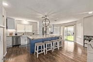 28422 N 32nd Ln, Phoenix, AZ 85083 - kitchen with white cabinets, dishwasher, a kitchen island, hanging light fixtures, and light countertops