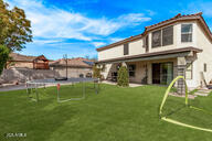 28422 N 32nd Ln, Phoenix, AZ 85083 - back of house featuring a trampoline and a lawn
