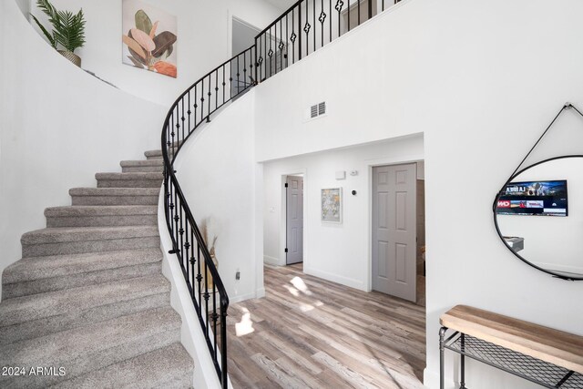 2818 N Yucca St, Chandler, AZ 85224 - staircase with wood finished floors, a towering ceiling, baseboards, and visible vents