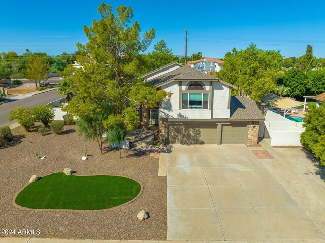 2818 N Yucca St, Chandler, AZ 85224 - view of front of property with roof with shingles, stucco siding, a garage, and concrete driveway
