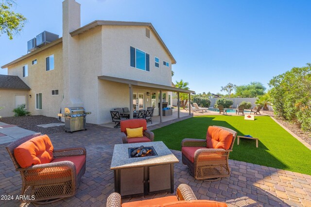 2818 N Yucca St, Chandler, AZ 85224 - view of patio / terrace featuring central air condition unit, grilling area, an outdoor living space with a fire pit, and a fenced in pool