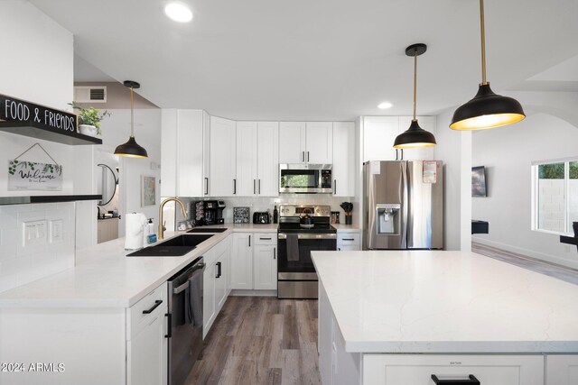 2818 N Yucca St, Chandler, AZ 85224 - kitchen featuring wood finished floors, a sink, stainless steel appliances, and decorative backsplash