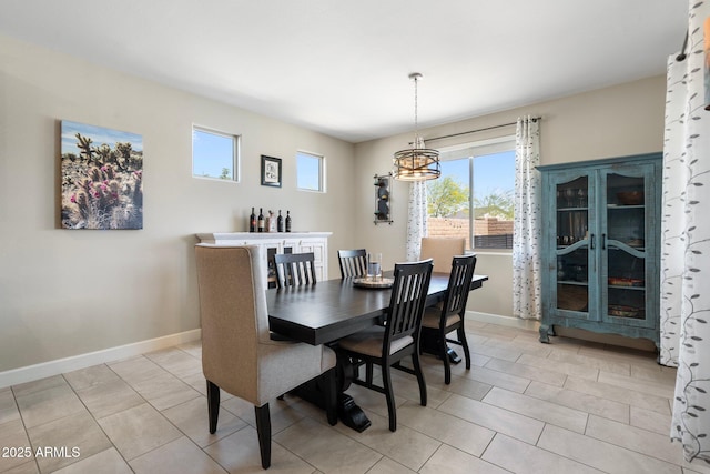 15663 S 183rd Dr, Goodyear, AZ 85338 - dining area featuring baseboards, a notable chandelier, and light tile patterned floors