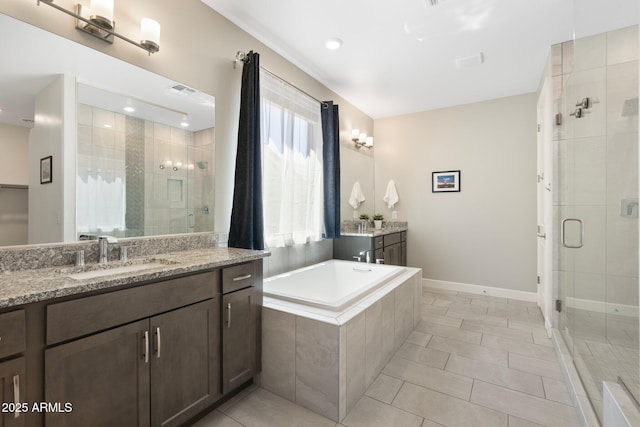 15663 S 183rd Dr, Goodyear, AZ 85338 - full bath with two vanities, baseboards, a sink, and a shower stall