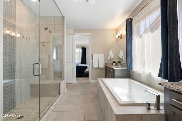 15663 S 183rd Dr, Goodyear, AZ 85338 - full bathroom with a stall shower, vanity, connected bathroom, and a healthy amount of sunlight
