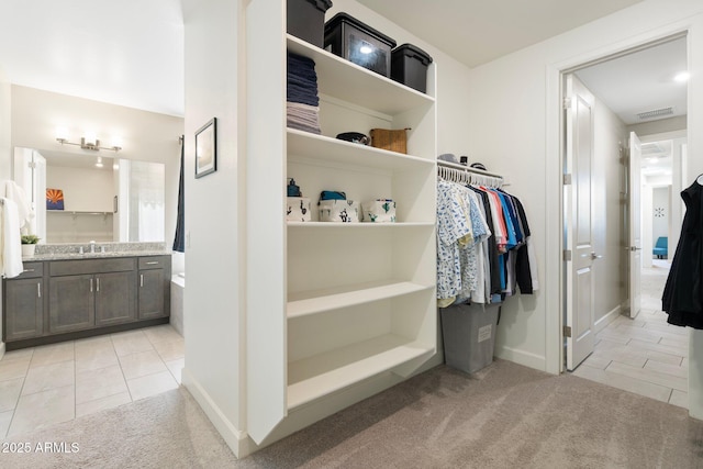 15663 S 183rd Dr, Goodyear, AZ 85338 - walk in closet featuring light carpet, visible vents, and light tile patterned floors