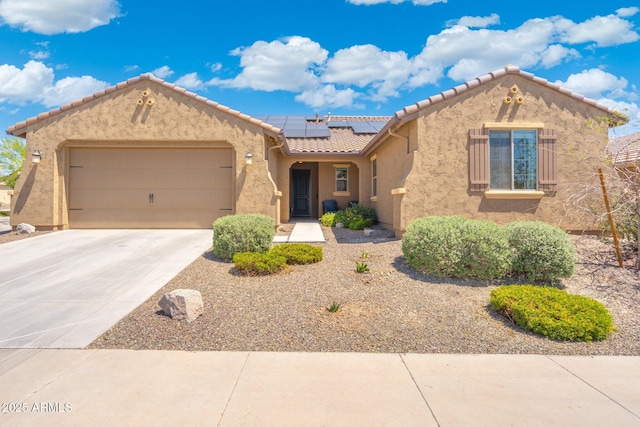 15663 S 183rd Dr, Goodyear, AZ 85338 - view of front facade featuring a tiled roof, solar panels, driveway, an attached garage, and stucco siding