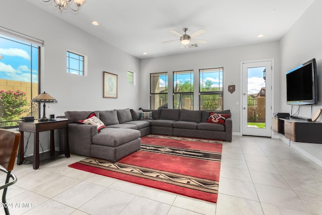 living room with light tile patterned floors, baseboards, recessed lighting, and ceiling fan with notable chandelier