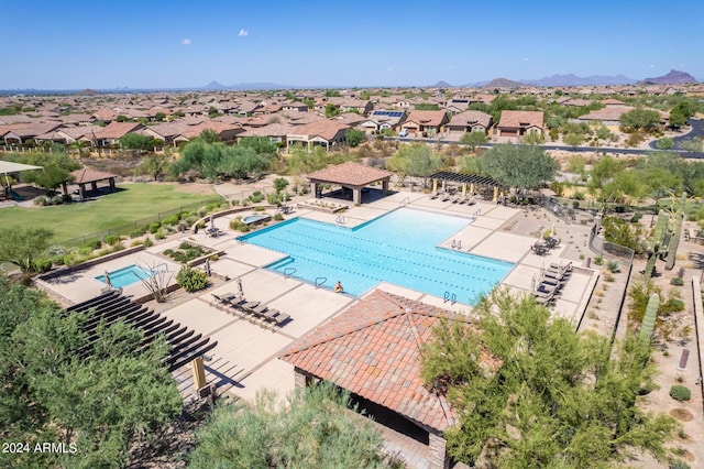 community pool with a gazebo, a residential view, a patio, and fence