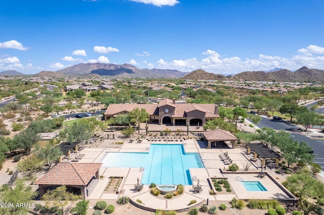 pool with a mountain view, a patio, and fence
