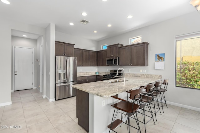 kitchen featuring a wealth of natural light, visible vents, appliances with stainless steel finishes, and a peninsula