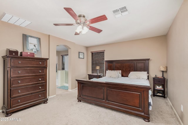 2748 E Dennisport Ave, Gilbert, AZ 85295 - bedroom featuring arched walkways, light carpet, baseboards, and ensuite bathroom