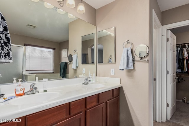 2748 E Dennisport Ave, Gilbert, AZ 85295 - bathroom featuring double vanity and a walk in closet