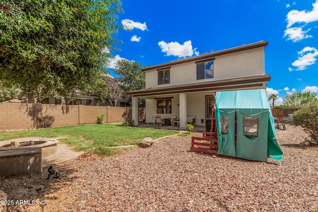 2748 E Dennisport Ave, Gilbert, AZ 85295 - rear view of house with stucco siding, a patio, and an outdoor fire pit