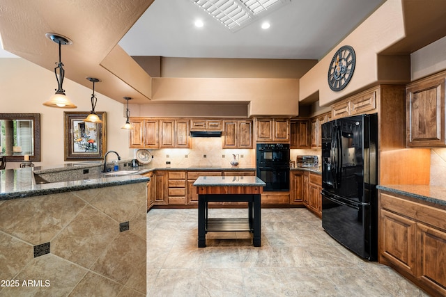 kitchen featuring a peninsula, black appliances, backsplash, and a sink